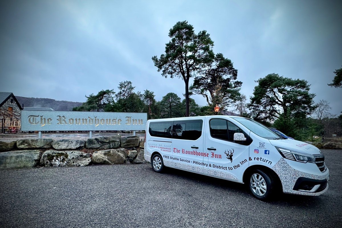 The Roundhouse Inn shuttle minibus on a Highland road at dusk